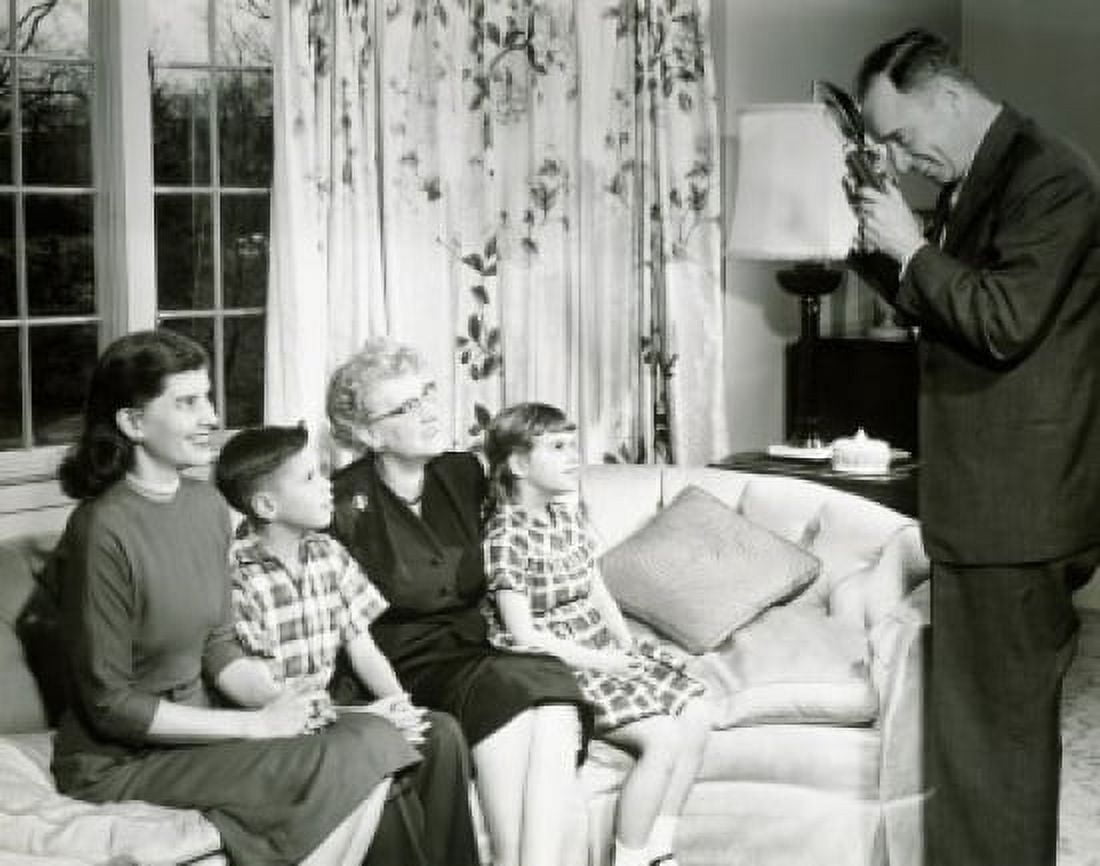 Man photographing family on sofa Canvas Art - (18 x 24)