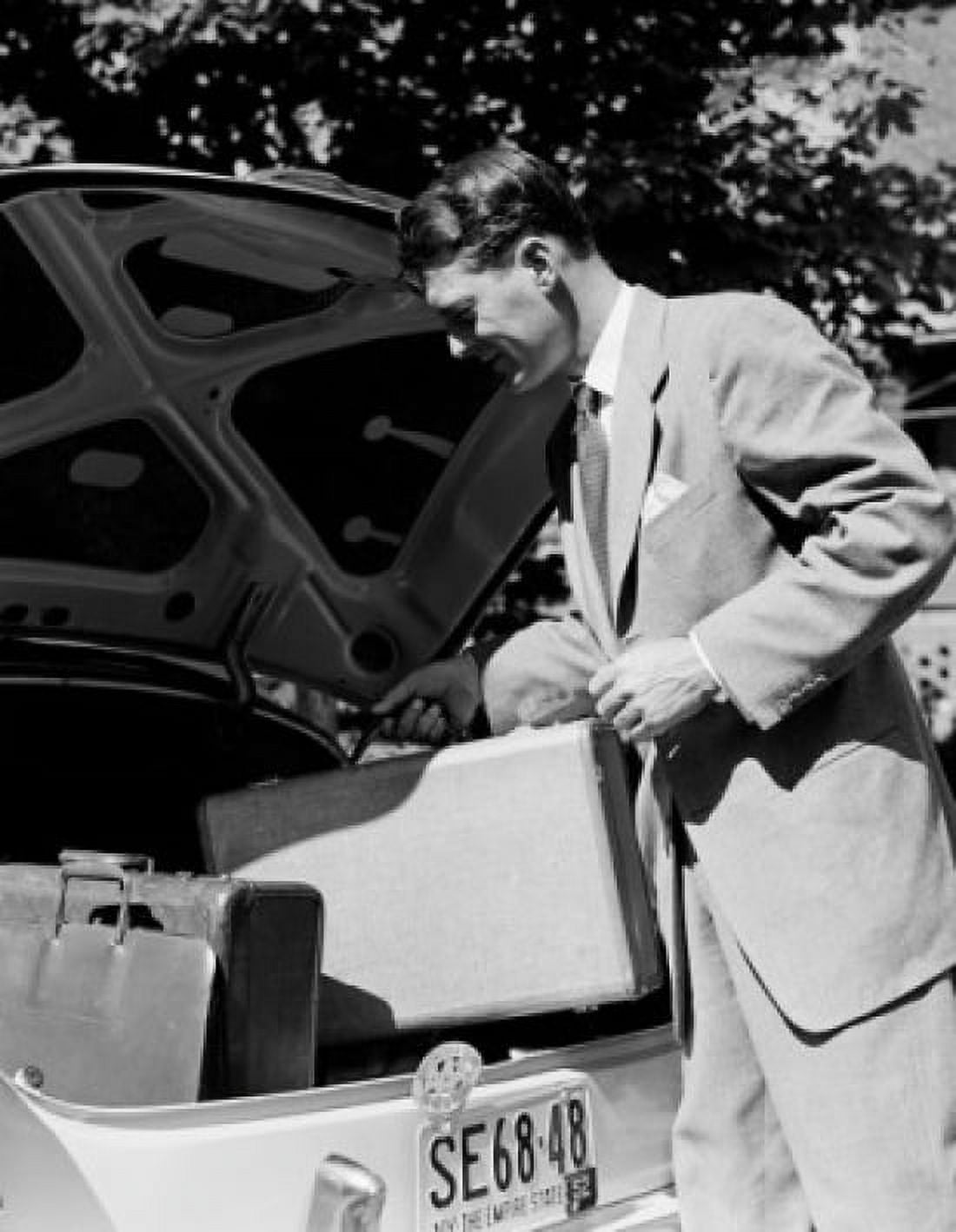 Man placing suitcase in car trunk Canvas Art - (18 x 24)