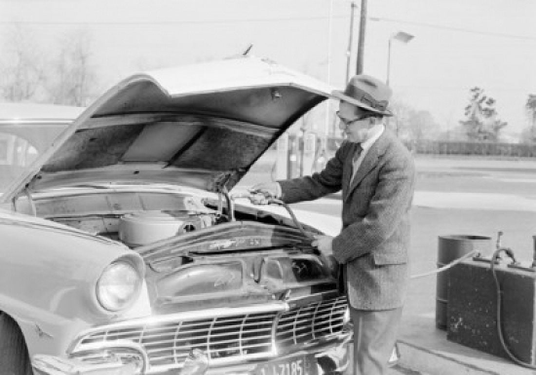 Man pouring water in car radiator Poster Print (18 x 24)