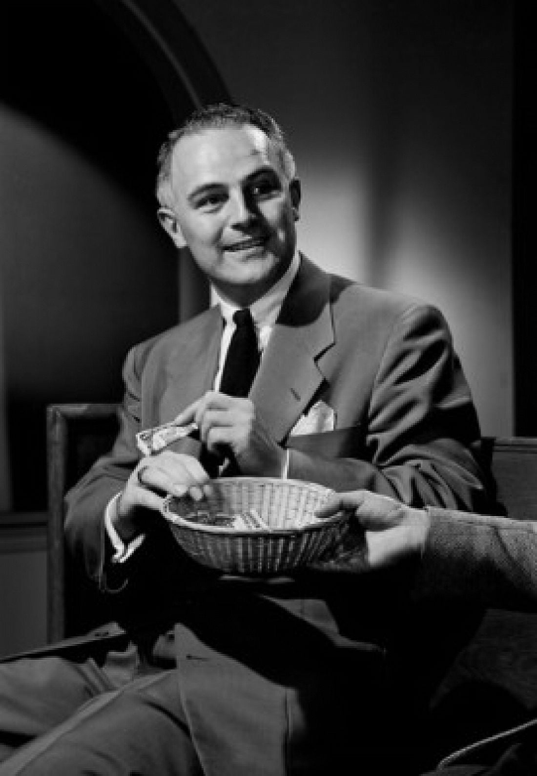 Man putting money into collection basket Canvas Art - (24 x 36)