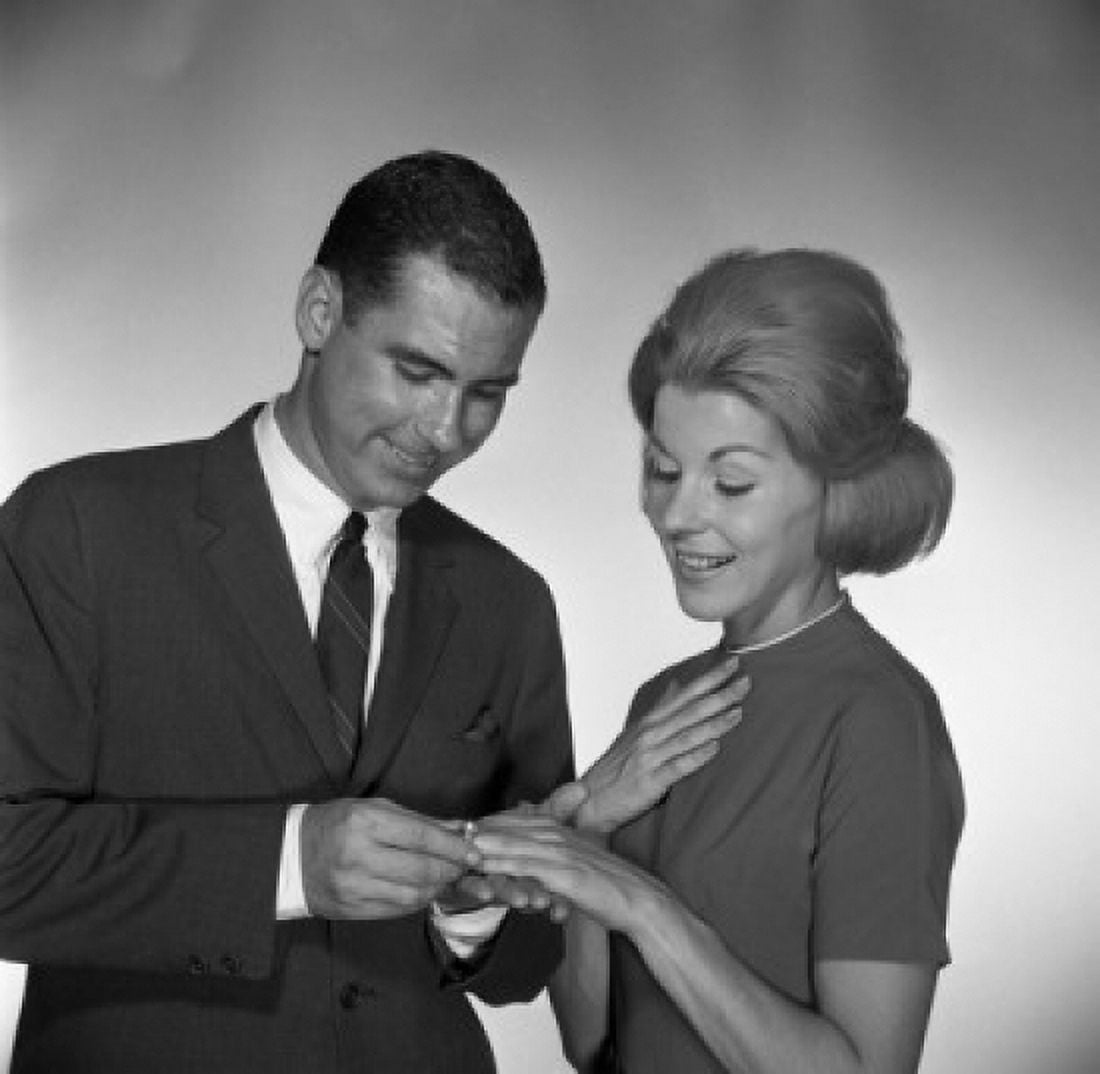 Man putting ring on womans palm studio shot Canvas Art - (24 x 36)