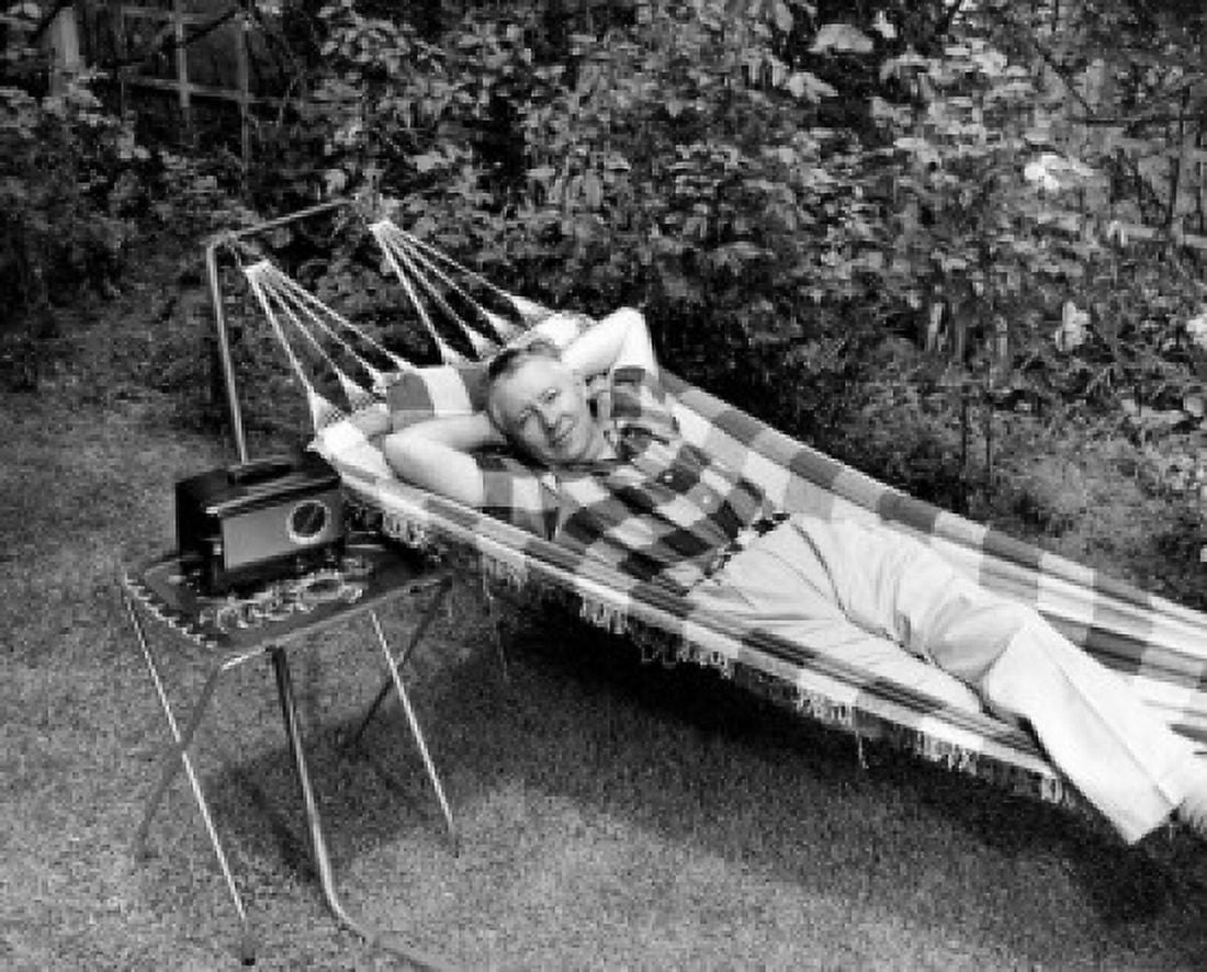 Man relaxing in hammock listening to radio Canvas Art - (18 x 24)