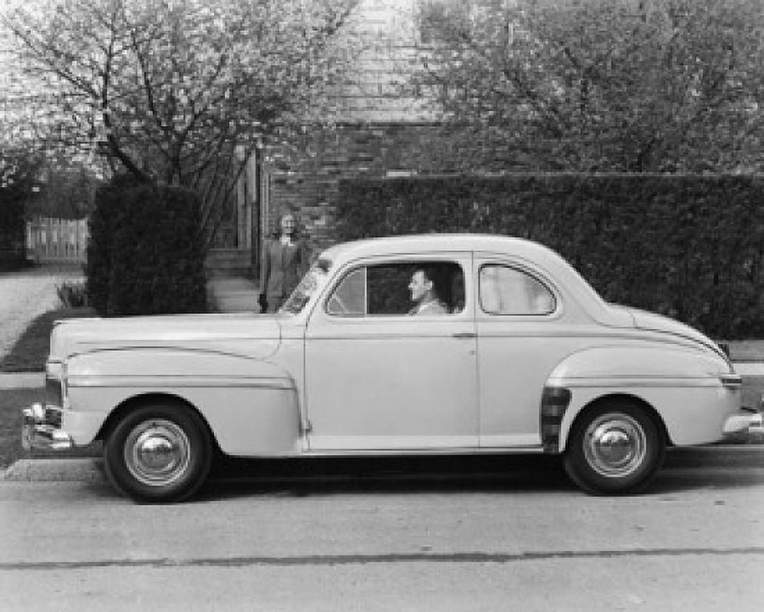 Man sitting in a 1946 Mercury Sedan Coupe with a woman standing beside it Canvas Art - (18 x 24)