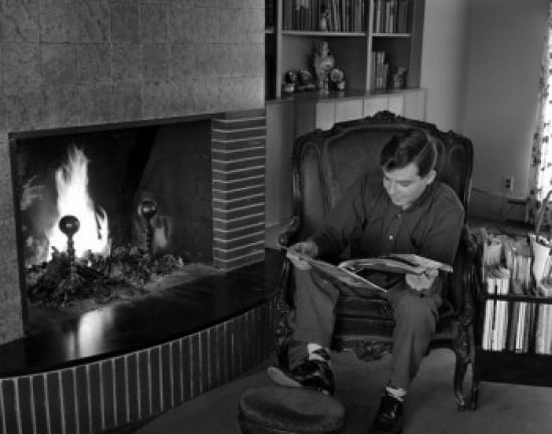 Man sitting in armchair by fireplace and riding Canvas Art - (18 x 24)