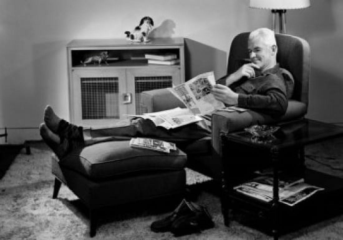 Man sitting in armchair with legs on footstool and reading newspaper Canvas Art - (18 x 24)