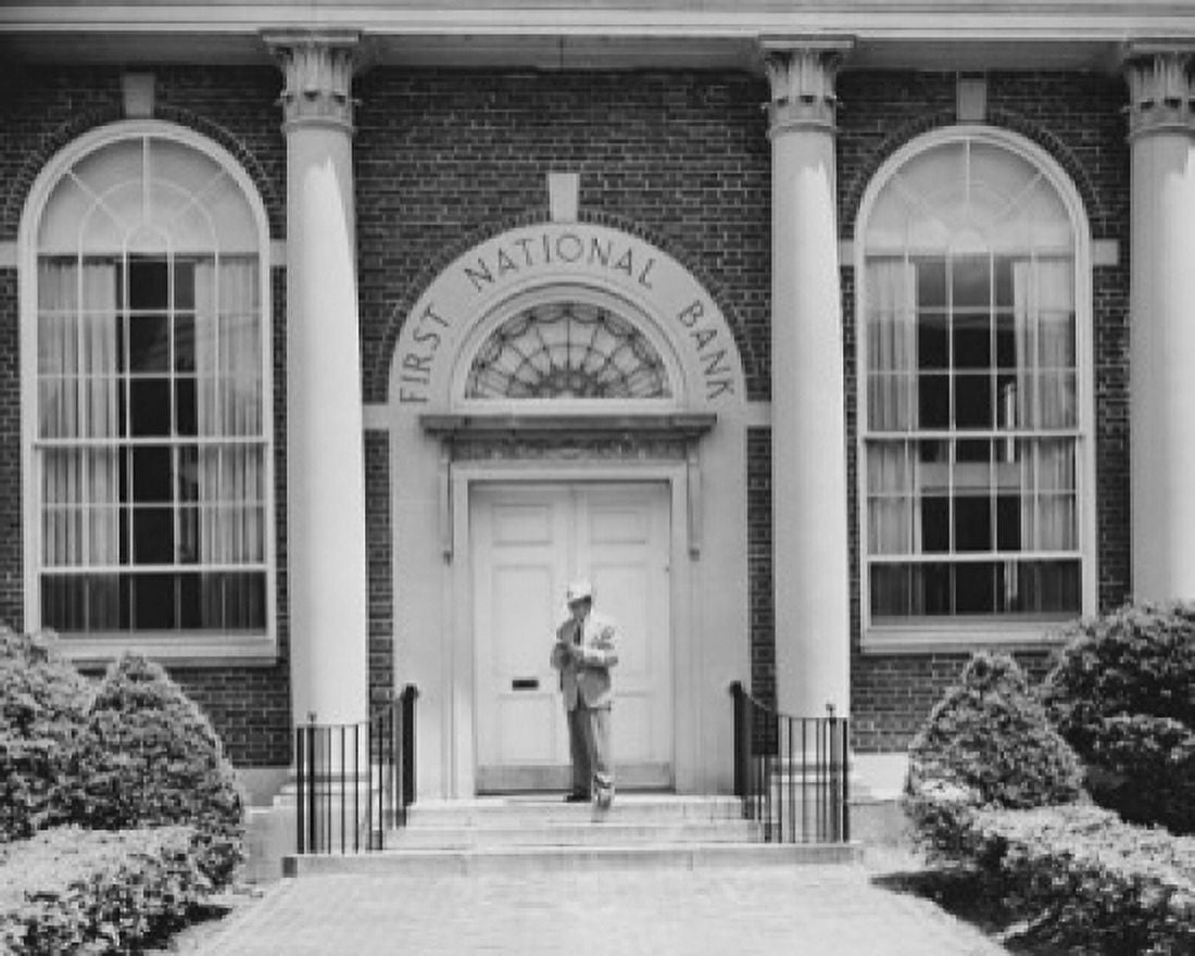 Man standing in front of the door of a bank Canvas Art - (24 x 36)