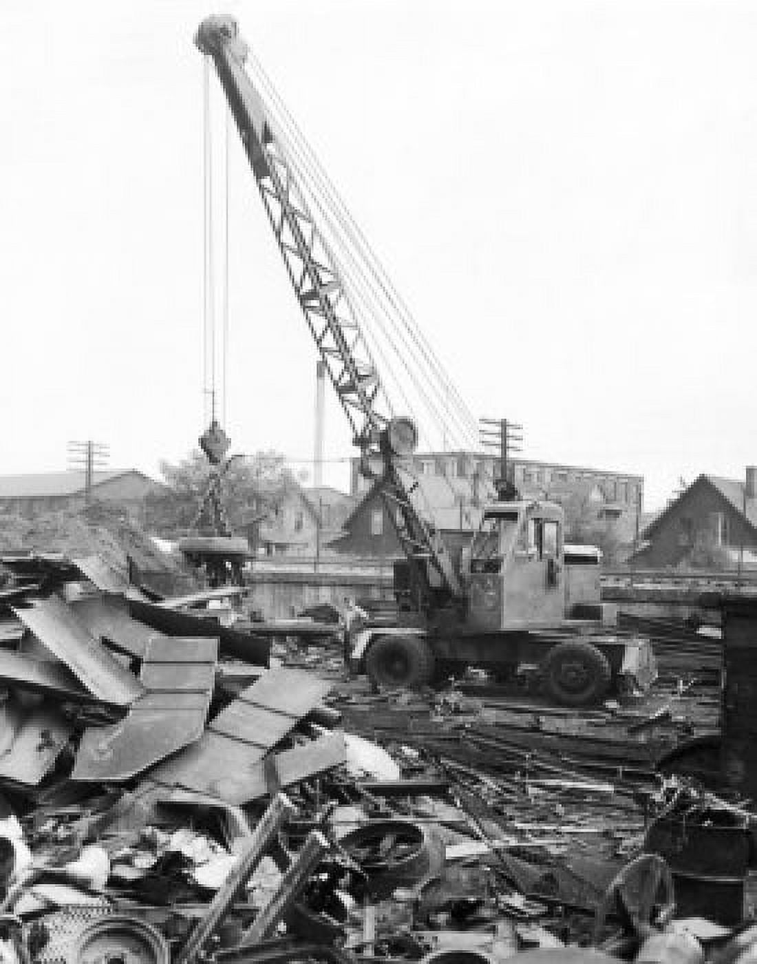 Man standing near a crane at a junkyard Canvas Art - (18 x 24)