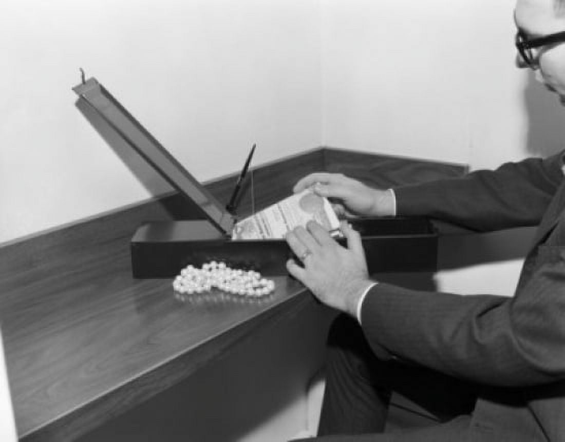 Man taking things out from safe deposit box in a bank Canvas Art - (24 x 36)