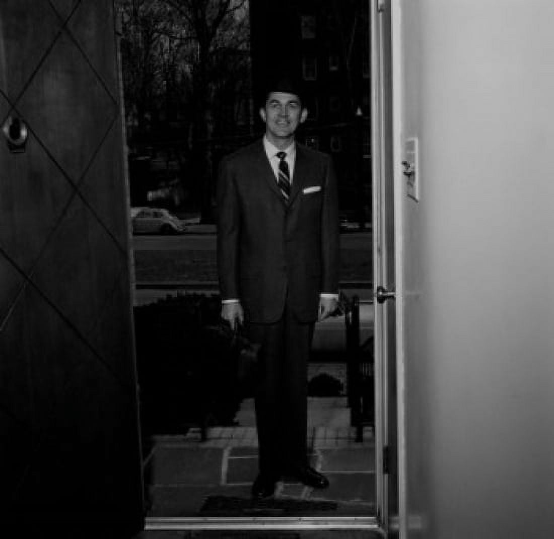 Man wearing suit standing in doorway of house Canvas Art - (24 x 36)