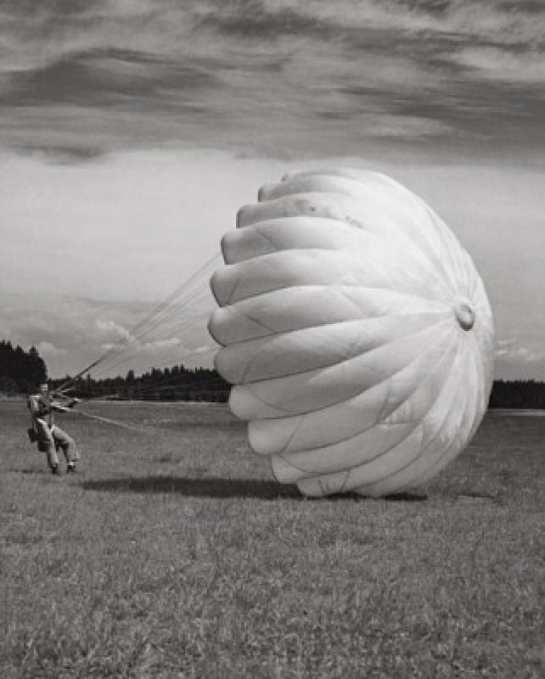 Man with a parachute landing in a field Canvas Art - (18 x 24)