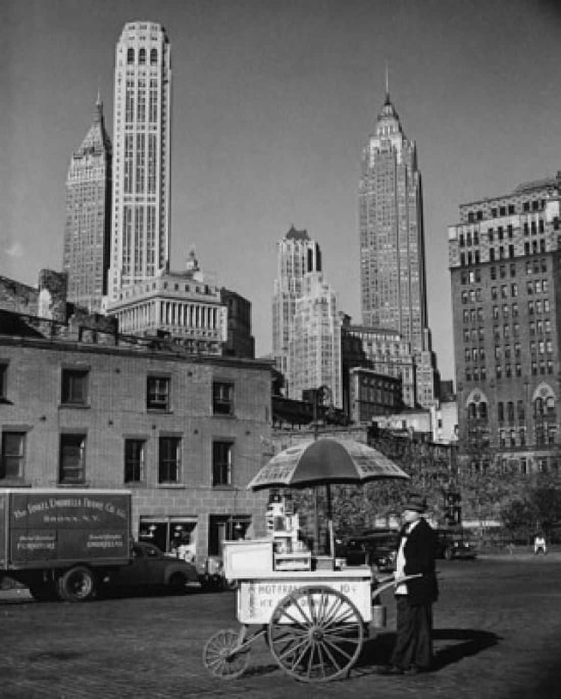 Man with a push cart in front of buildings New York City New York USA Canvas Art - (18 x 24)