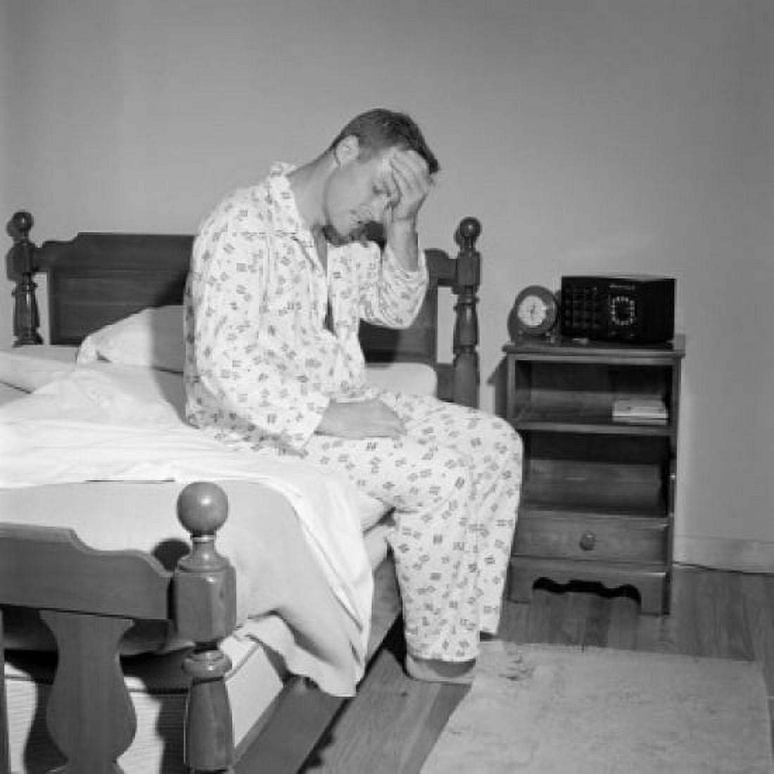 Man with headache sitting on bed Canvas Art - (24 x 36)