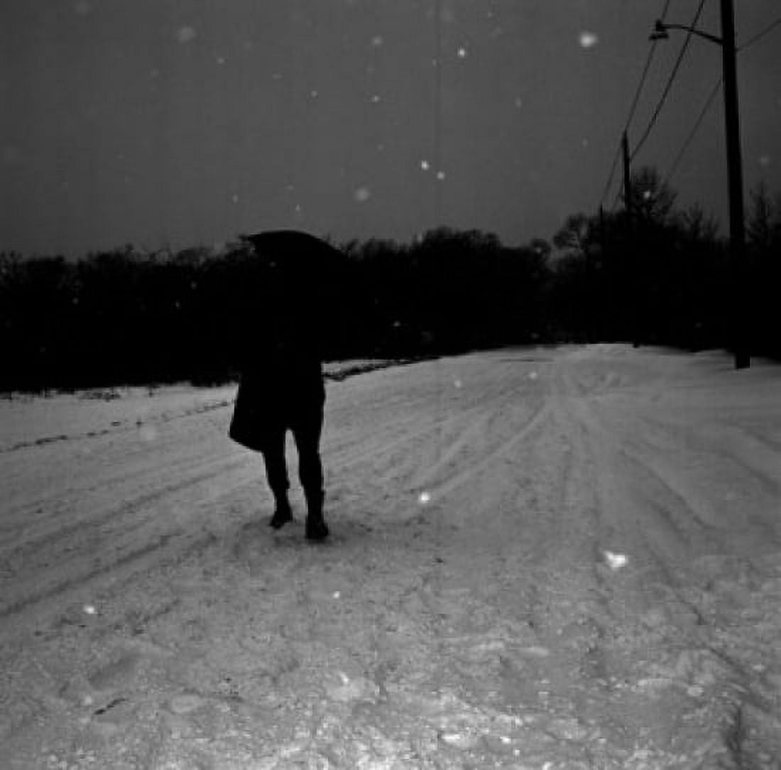 Man with umbrella walking on snow covered road Canvas Art - (18 x 24)