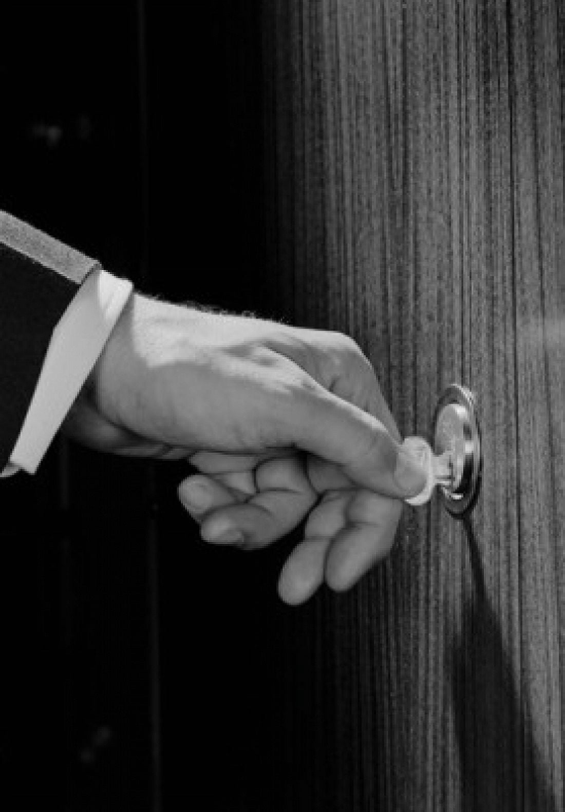 Mans hand turning key in door Canvas Art - (24 x 36)