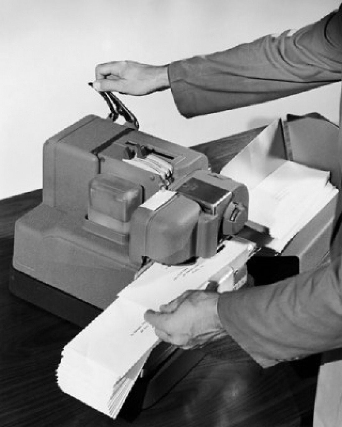 Mans hands operating a postage stamp machine Canvas Art - (24 x 36)