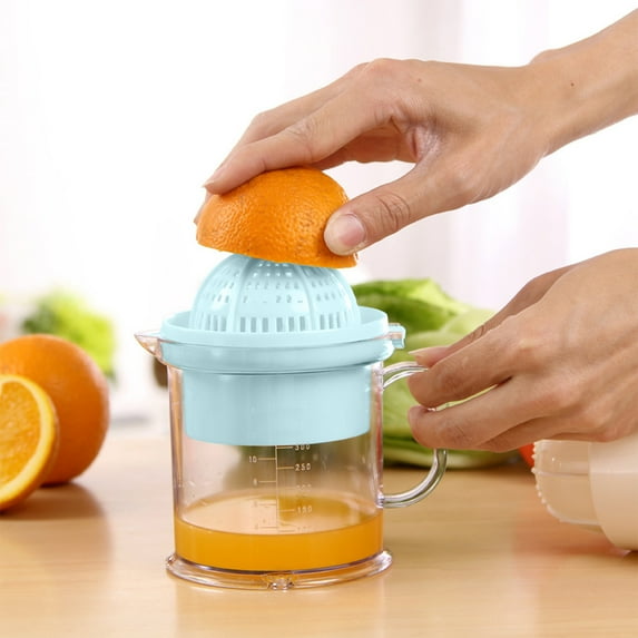 Manual Juicer Squeezes Lemon Separates Cup With Scale Holds Hand And Manual Juicer Squeezes Lemon Separates Cup With Scale Holds Hand And
