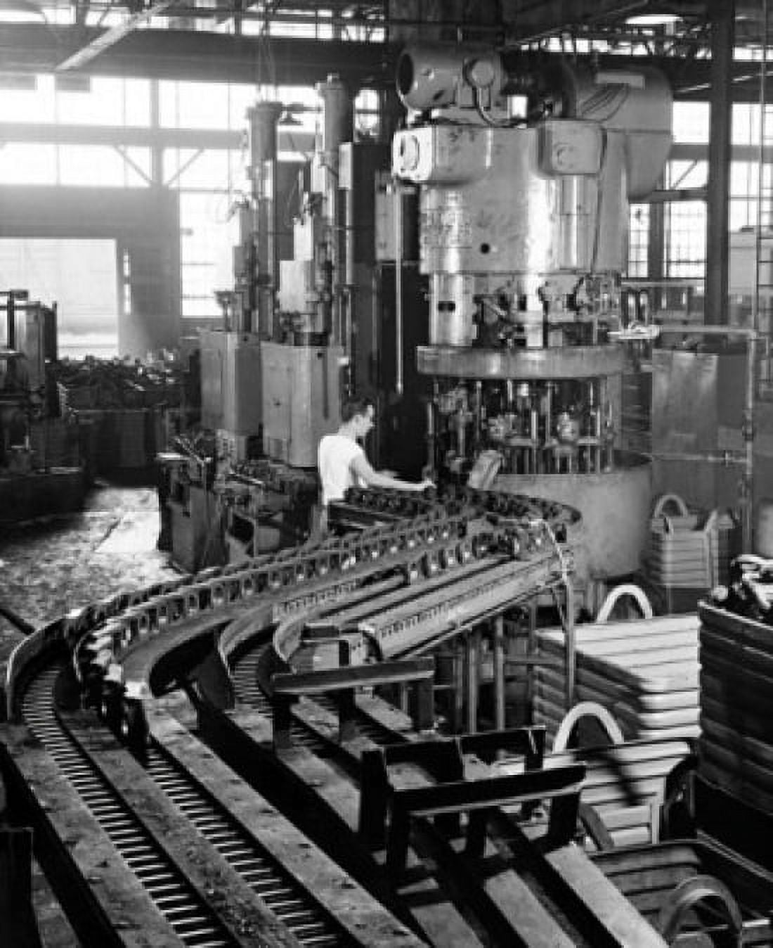 Manual worker drilling track links for tractors in a factory Canvas Art - (18 x 24)