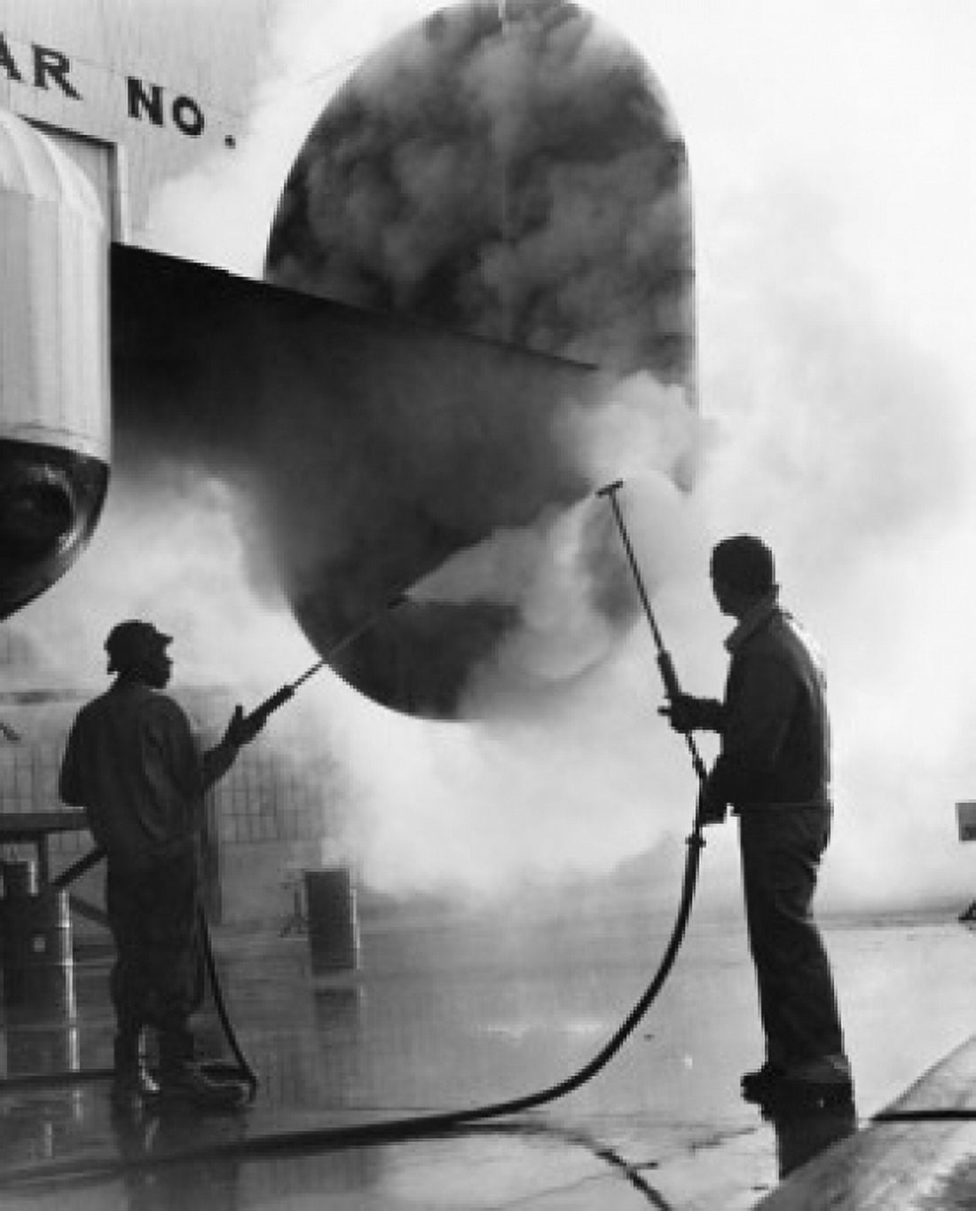 Manual workers cleaning airplane with steam Canvas Art - (18 x 24)