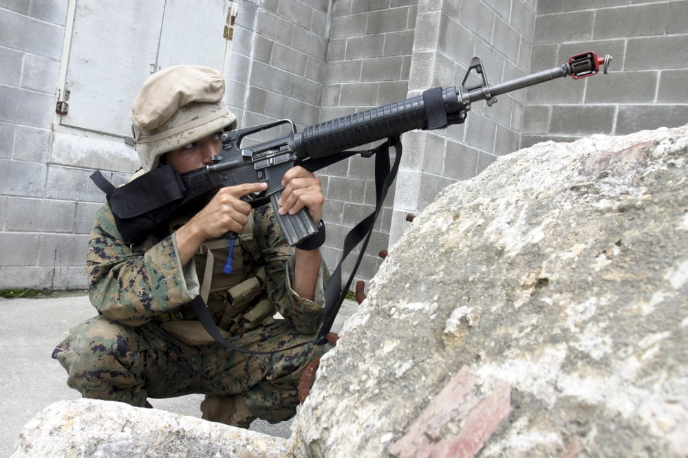 Marine scans the area for enemy activity while inside an abandoned building Canvas Art - Stocktrek Images (34 x 23)