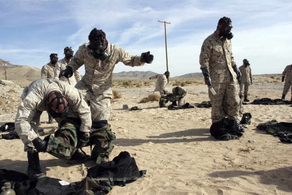 Marines and Sailors assist each other in taking off their protective suits Canvas Art - Stocktrek Images (34 x 23)