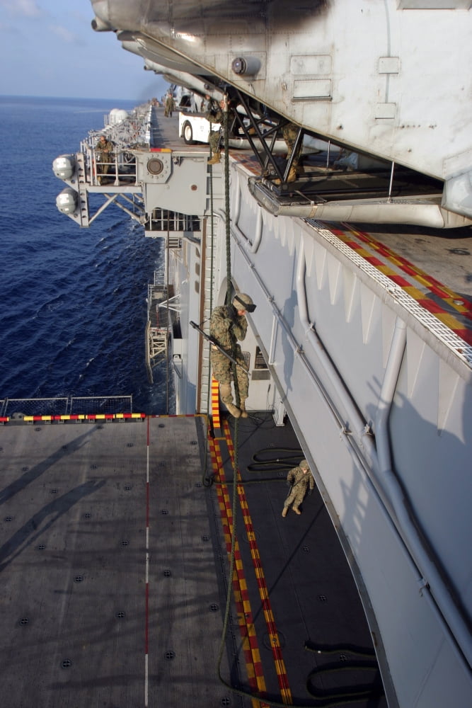 Marines and sailors fast-rope from the rear of a CH-46E Sea Knight Canvas Art - Stocktrek Images (23 x 34)