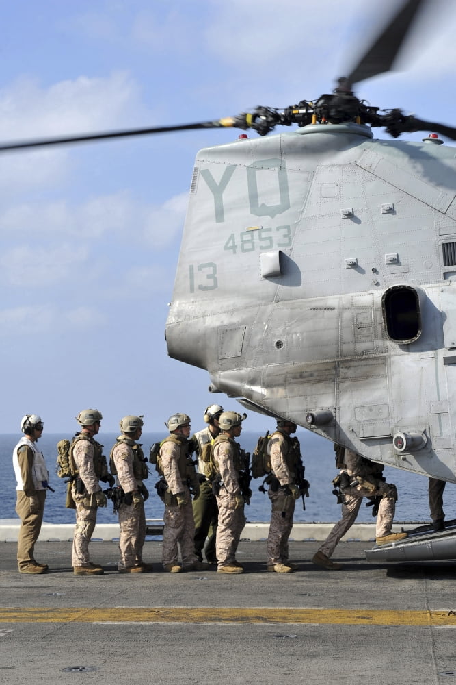 Marines board a CH-46E Sea Knight helicopter on the flight deck of USS Makin Island Canvas Art - Stocktrek Images (23 x 35)
