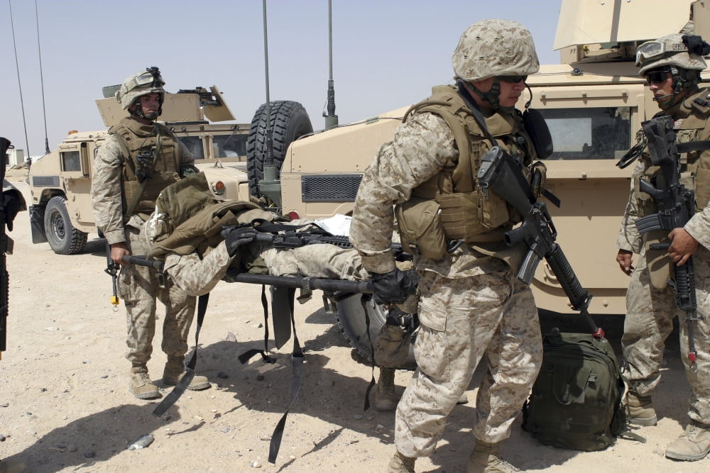 Marines carry a wounded comrade Canvas Art - Stocktrek Images (34 x 23)