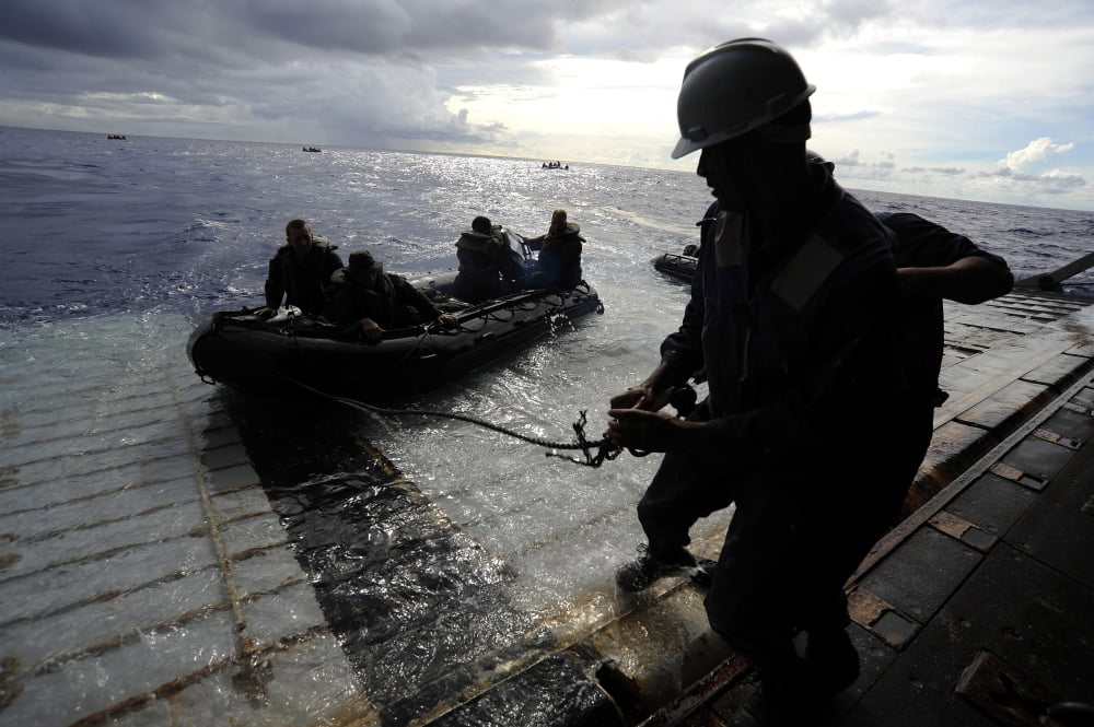 Marines in a combat rubber reconnaissance craft approach the stern gate of USS Harpers Ferry Canvas Art - Stocktrek Images (34 x 23)