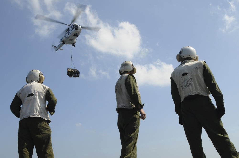 Marines wait to retrieve a pallet during a vertical replenishment Canvas Art - Stocktrek Images (35 x 24)