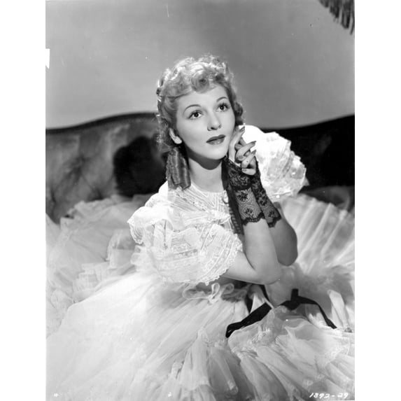 Mary Martin on a Ruffled Gown sitting on a Bed Photo Print (24 x 30)