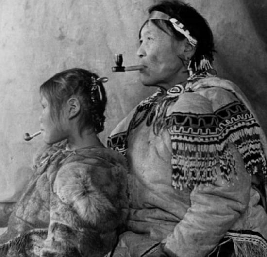 Mature Eskimo man smoking a pipe with his daughter Canvas Art - (18 x 24)