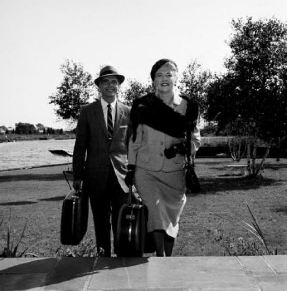 Mature couple carrying suitcases walking up stairs Canvas Art - (24 x 36)