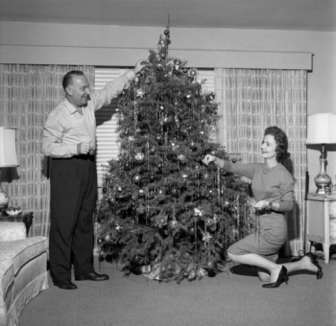 Mature couple decorating Christmas tree Canvas Art - (18 x 24)
