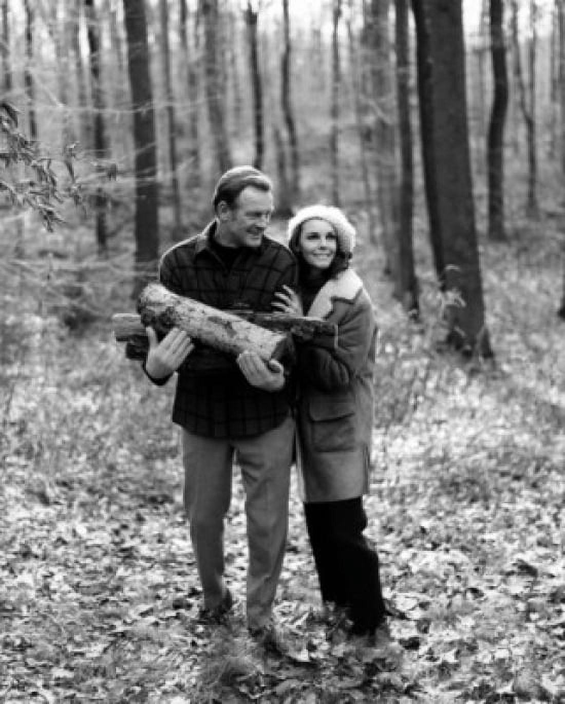 Mature couple in forest man holding firewood Canvas Art - (18 x 24)