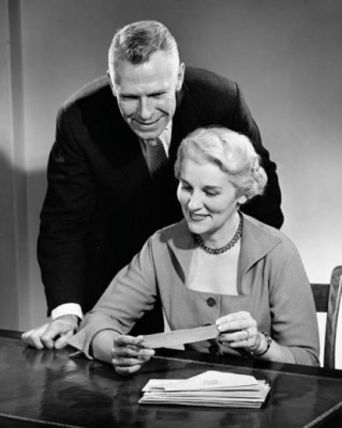 Mature couple looking at mail and smiling Canvas Art - (24 x 36)