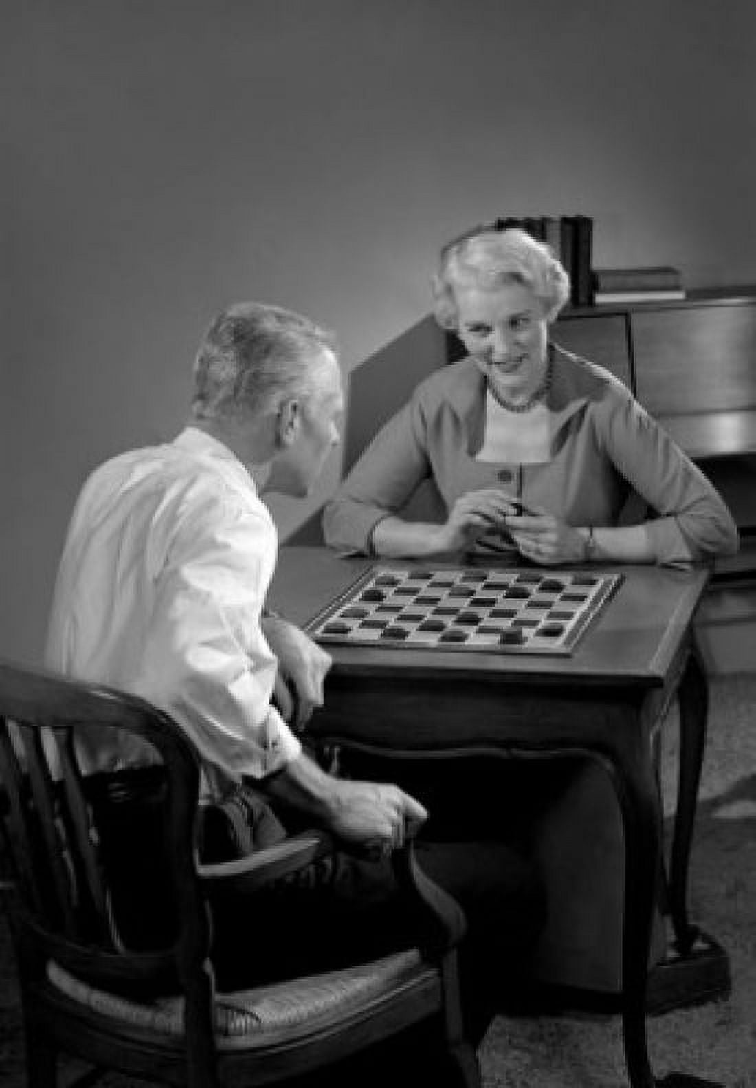 Mature couple playing board game Canvas Art - (24 x 36)