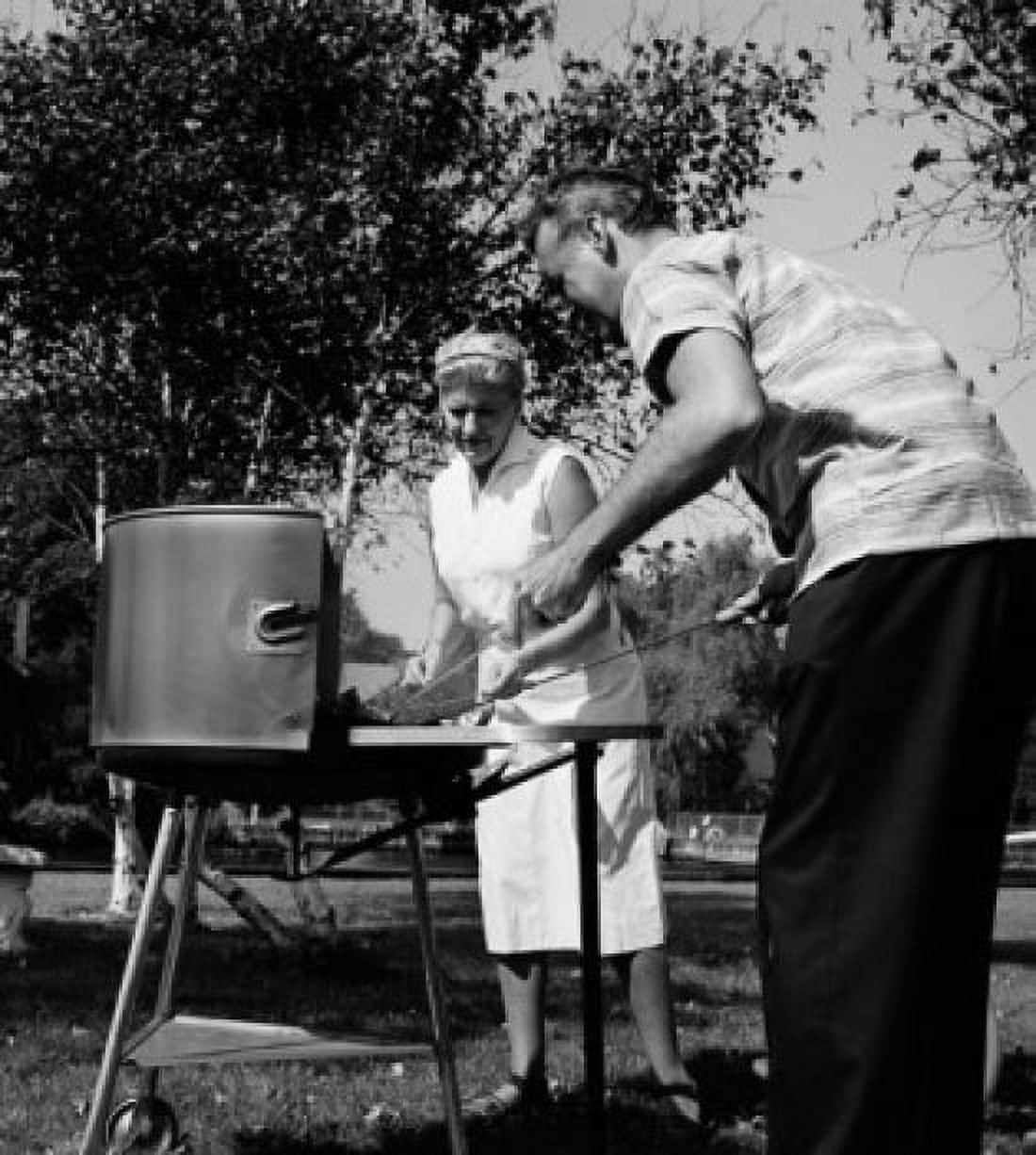Mature couple preparing barbecue Canvas Art - (18 x 24)