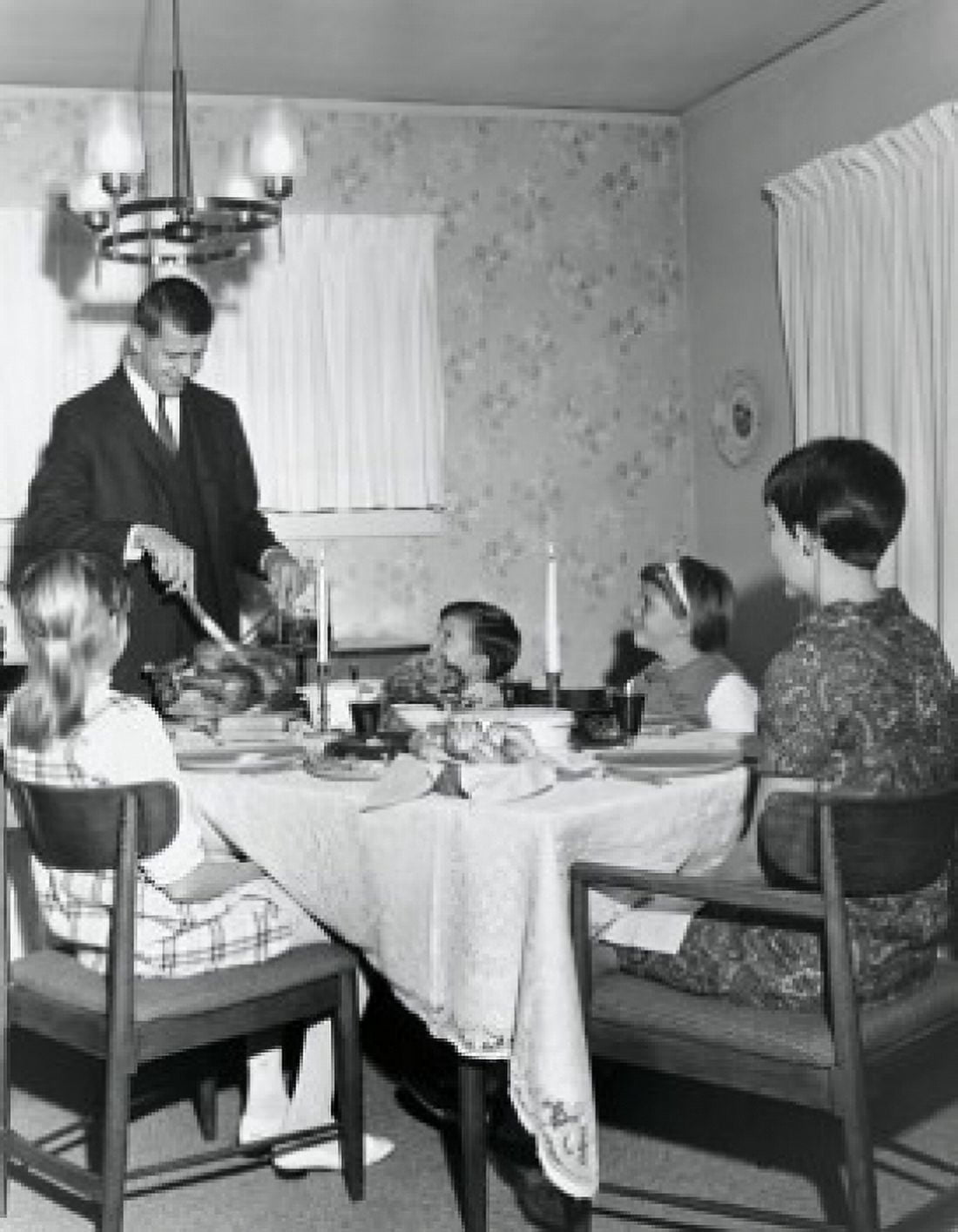 Mature couple sitting at a dining table with their children on Thanksgiving Day Canvas Art - (18 x 24)