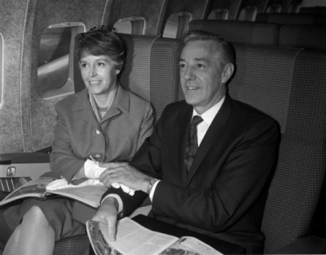 Mature couple sitting in plane and holding hands Canvas Art - (24 x 36)