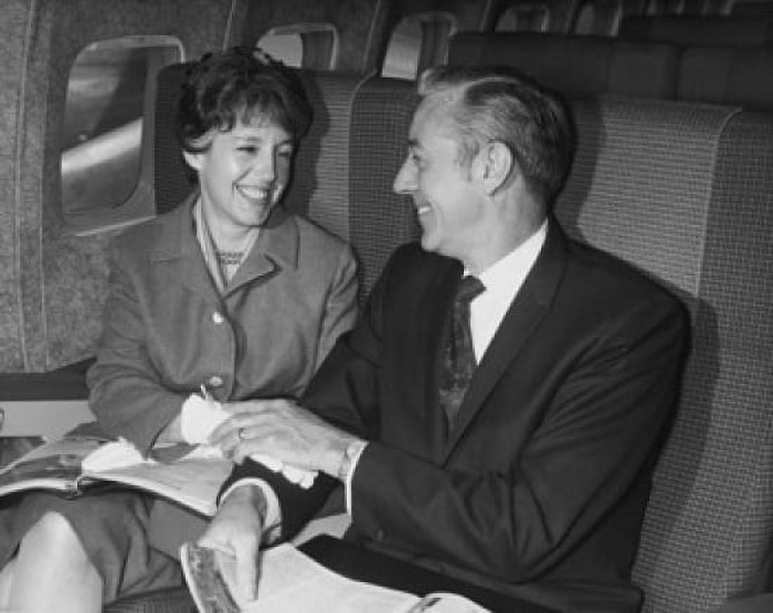 Mature couple sitting on an airplane and smiling at each other Canvas Art - (24 x 36)