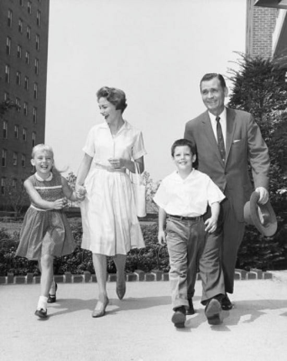 Mature couple walking with their son and daughter Canvas Art - (24 x 36)