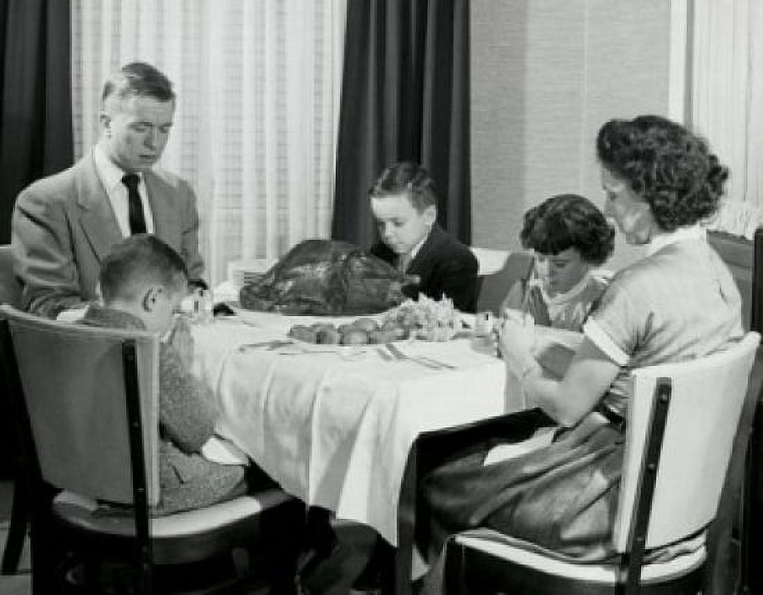Mature couple with their children praying at a dining table on Thanksgiving Day Canvas Art - (18 x 24)
