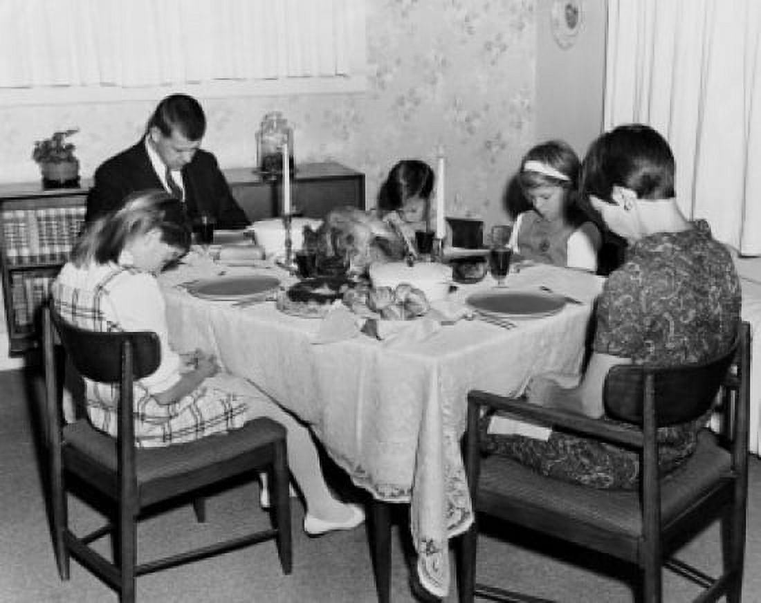 Mature couple with their three children praying at a dining table on Thanksgiving Day Canvas Art - (18 x 24)