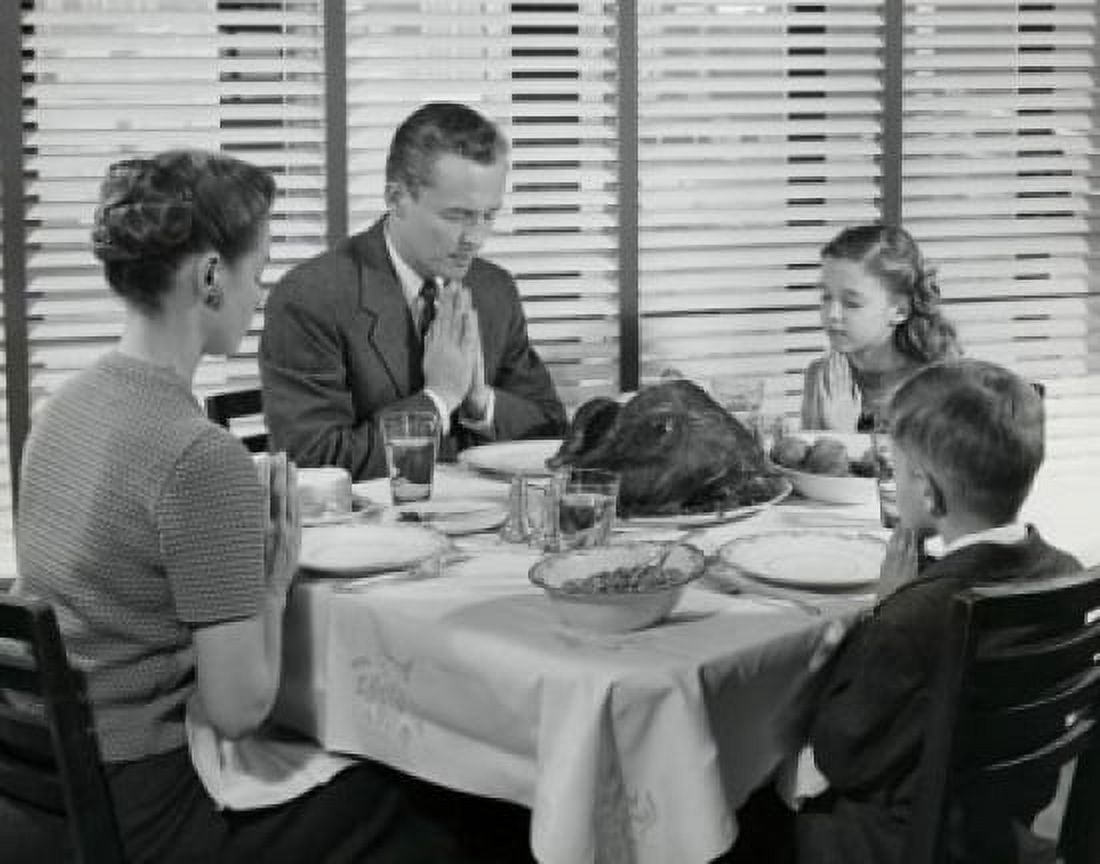 Mature couple with their two children praying at a dining table on Thanksgiving Day Canvas Art - (18 x 24)