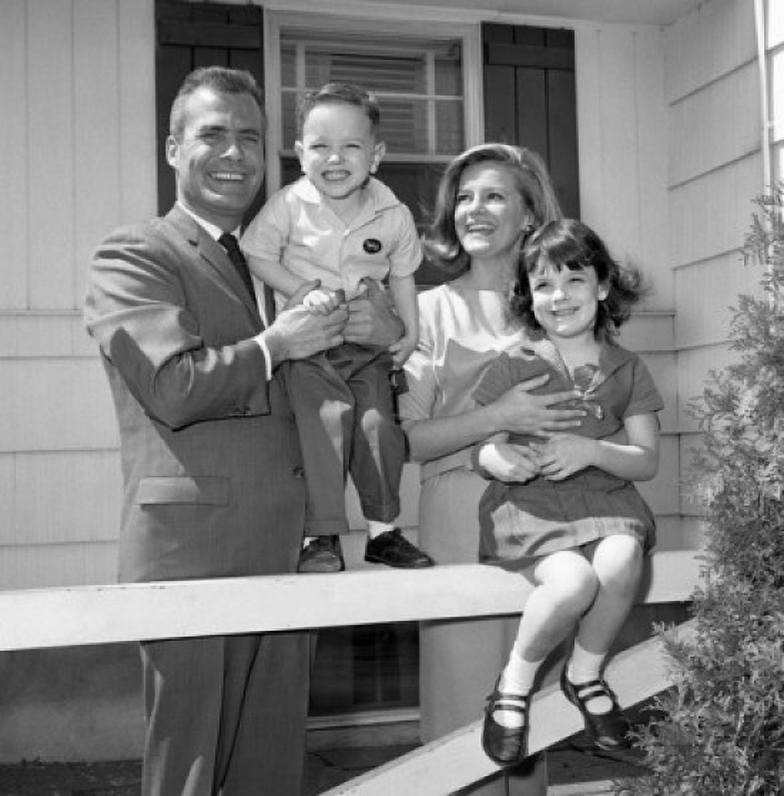 Mature couple with two children in front of the house Canvas Art - (24 x 36)