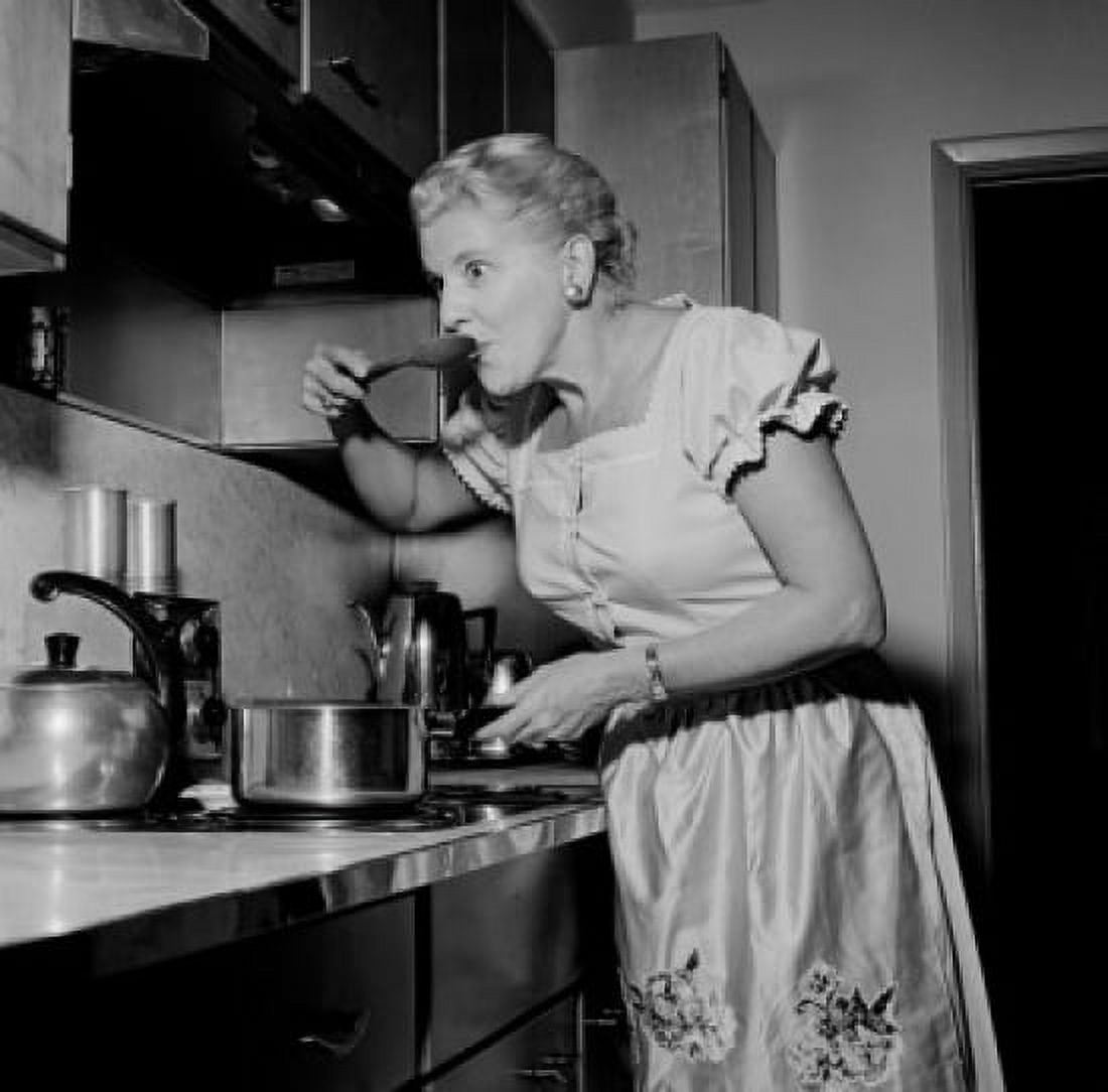 Mature housewife tasting food Canvas Art - (24 x 36)