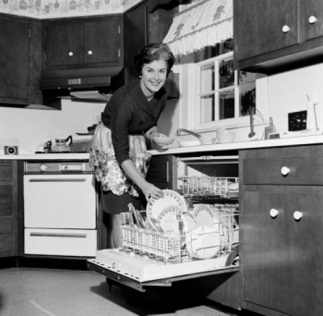 Mature housewife washing dishes in dishwasher Canvas Art - (18 x 24)