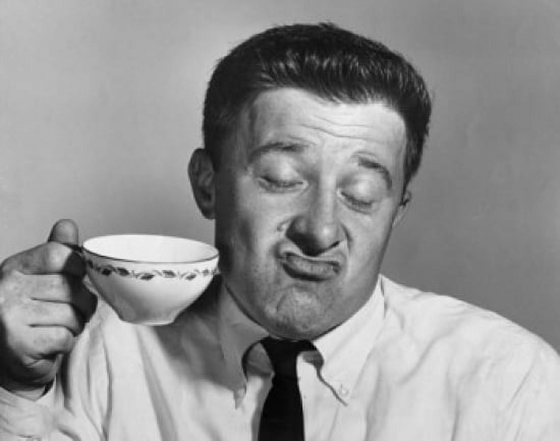 Mature man holding tea cup and making a face Canvas Art - (24 x 36)