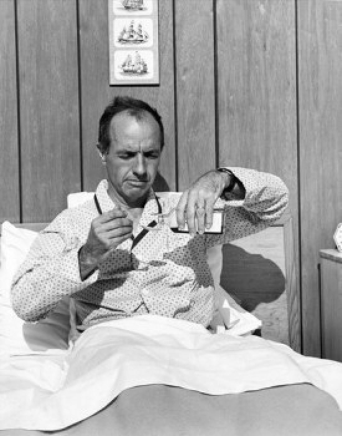 Mature man in bed pouring medicine into a spoon Canvas Art - (18 x 24)