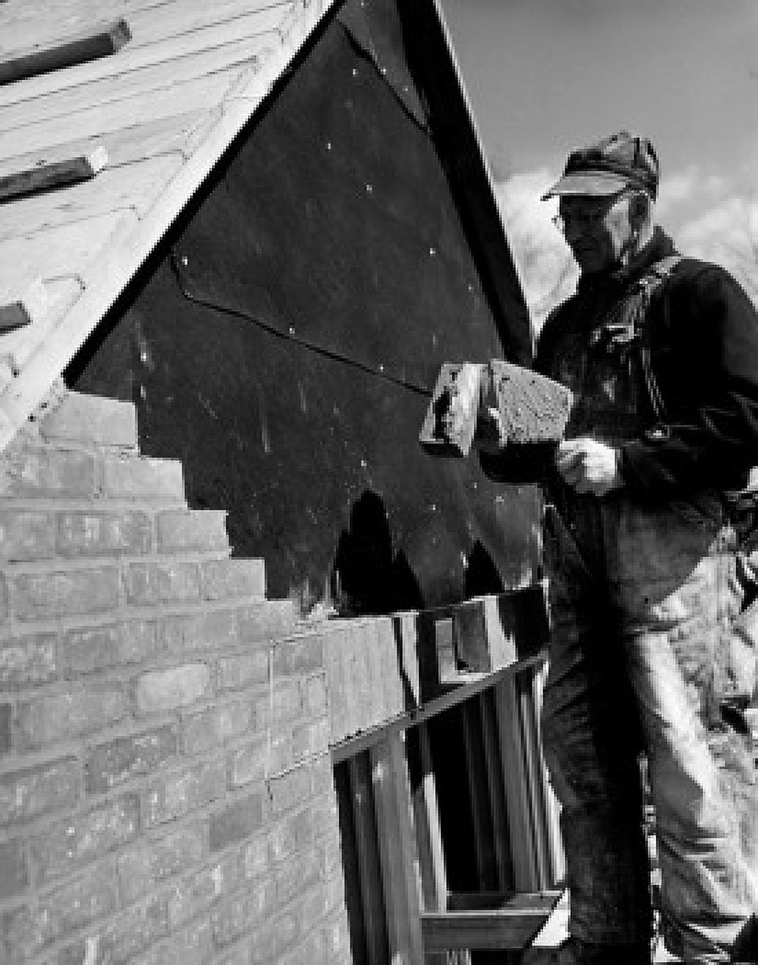 Mature man making brick layer on building Canvas Art - (24 x 36)
